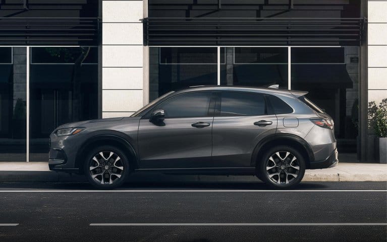 2028 Honda HR-V EX-L in Modern Steel Metallic profile view parked on a city street (Subcompact Crossover SUV).
